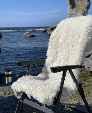White sheepskin rugs throw over chair or sofa